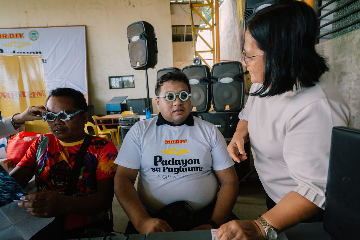 Beneficiary fitted with free eyeglasses at the mission