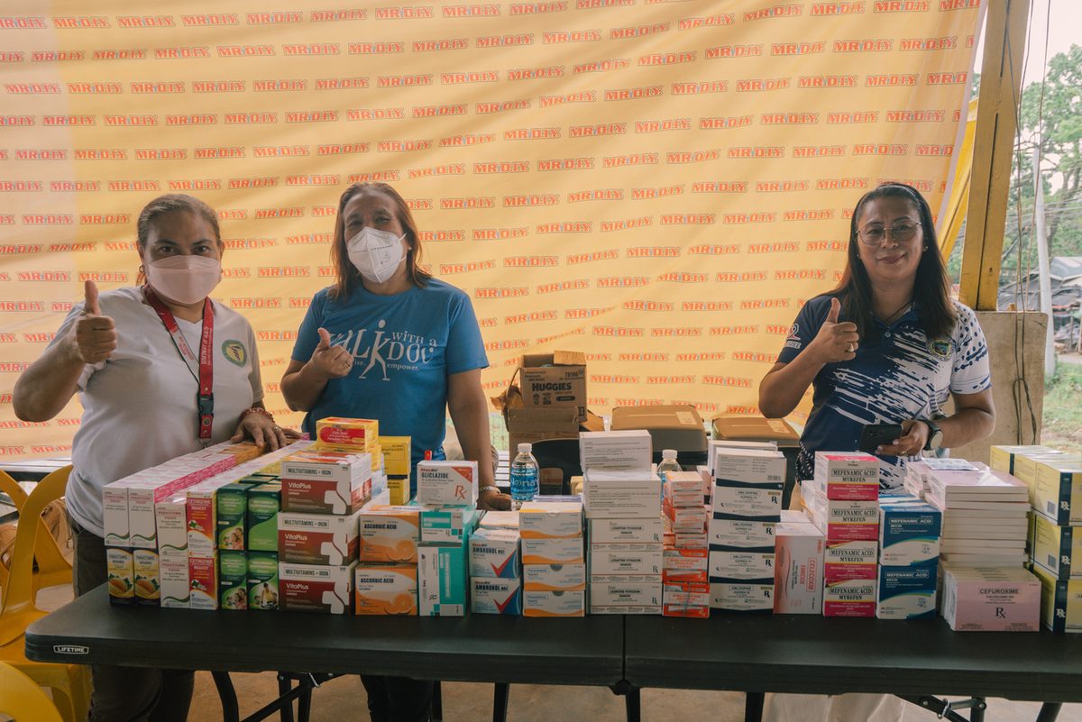 Volunteers distributing free medicines at the mission pharmacy table